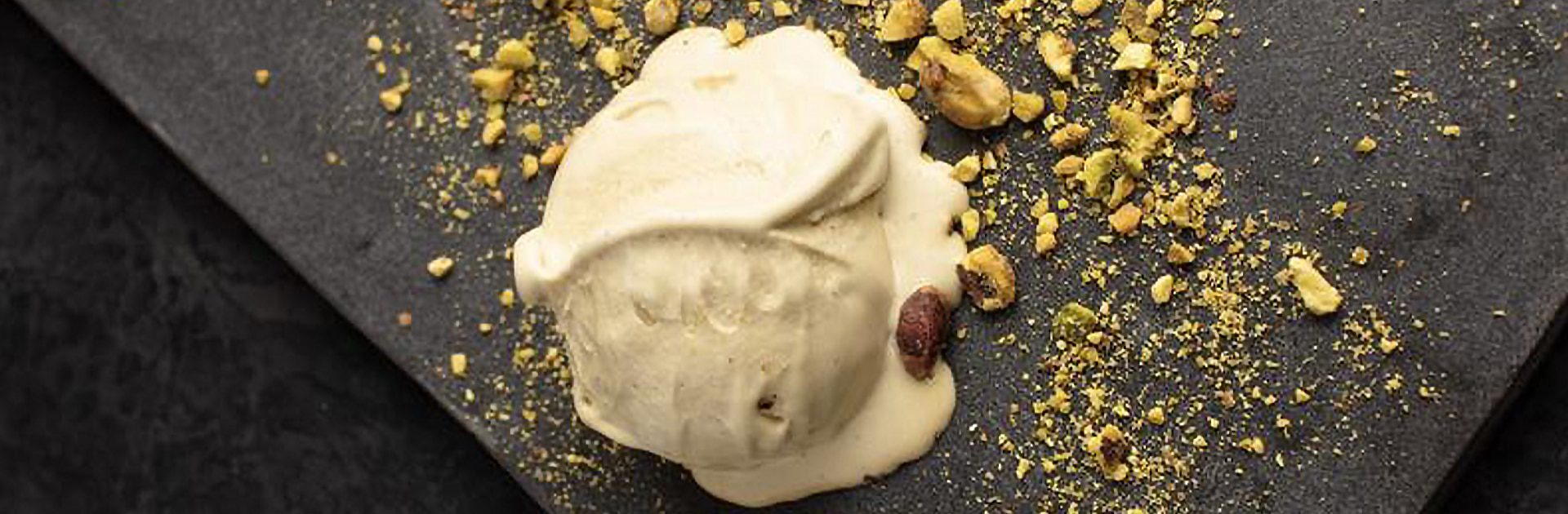 Chef-plated scoop of pistachio gelato